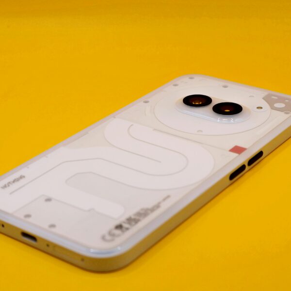 A modern smartphone with dual cameras on a vivid yellow background. Minimalist tech vibe.