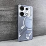 A sleek smartphone with a futuristic design rests on a wooden surface, showcasing modern technology.